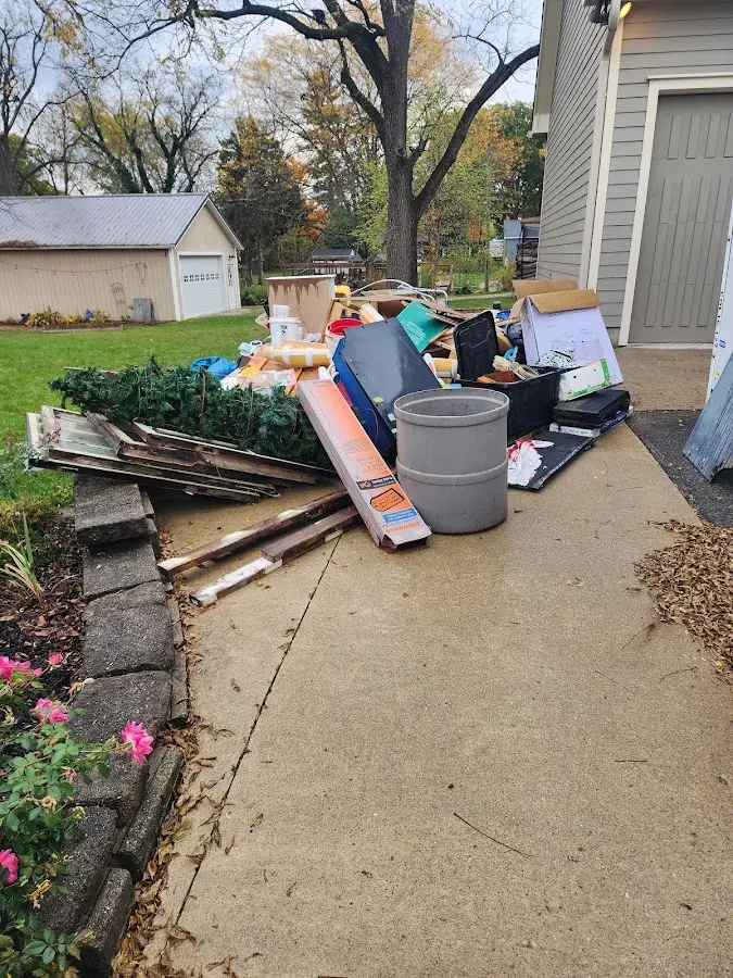 Dumpster being loaded with debris for Estate Cleanout Dumpster Rental in Tyngsborough